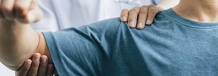A physiotherapist performing an arm exam.