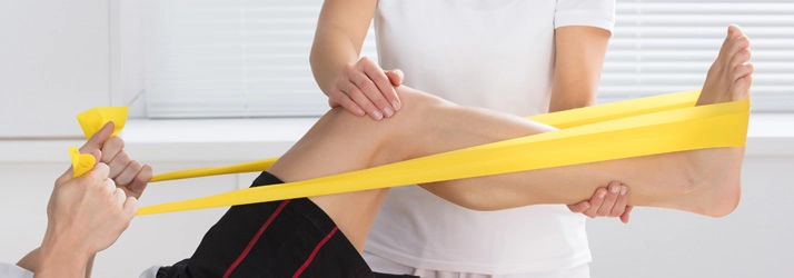 A patient using a yellow band for Physiotherapy.